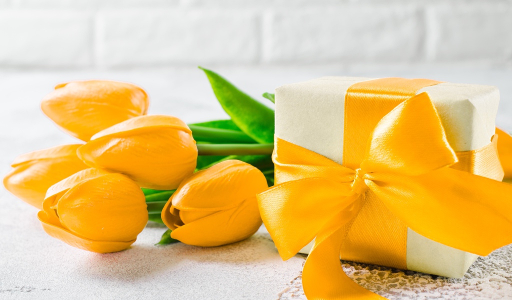 Красивый букет желтых тюльпанов с подарком