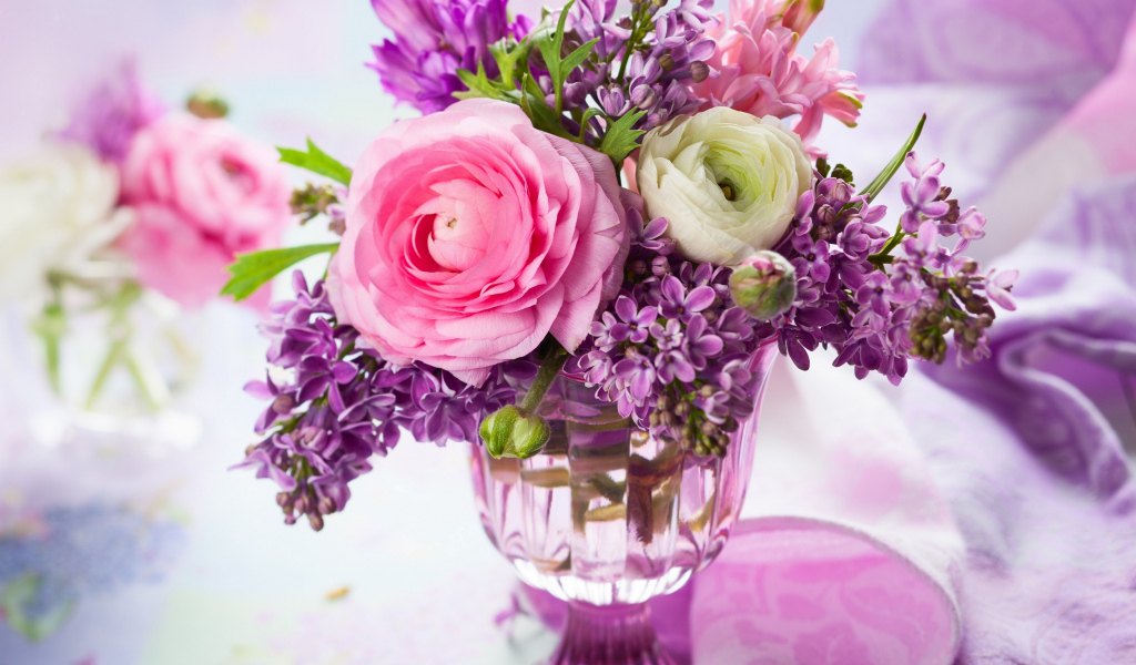 Beautiful buttercups and lilac flowers in a vase