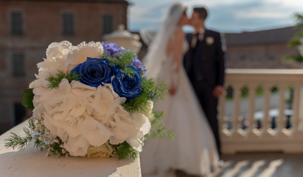 Свадебный букет на фоне новобрачной пары 