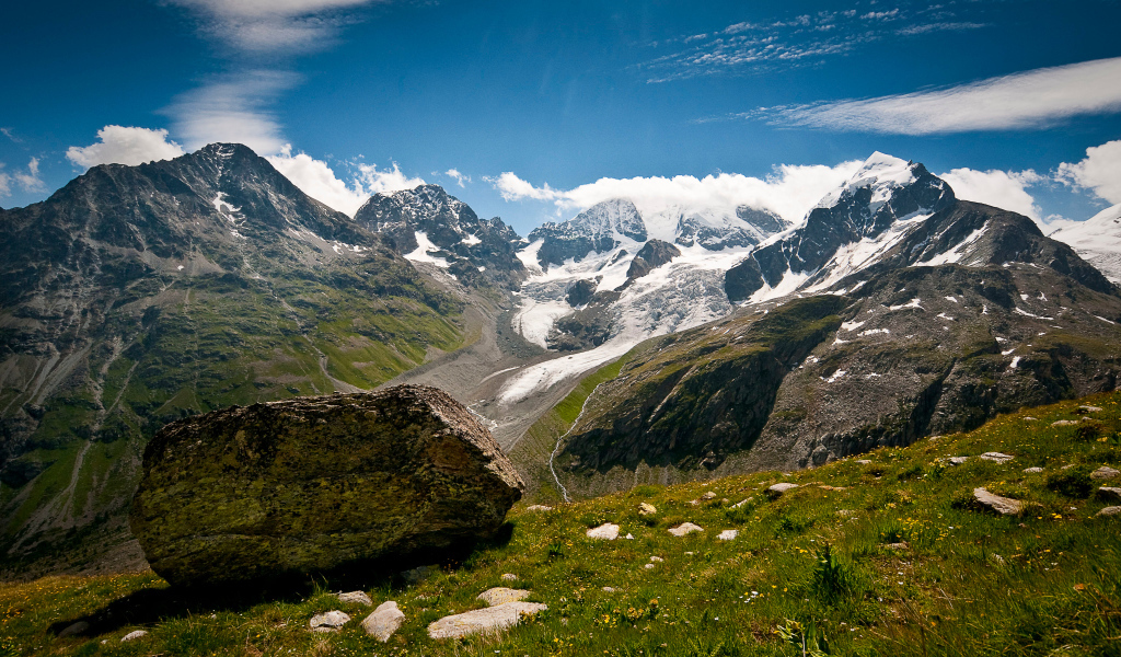 Высокие заснеженные швейцарские горы под голубым небом 
