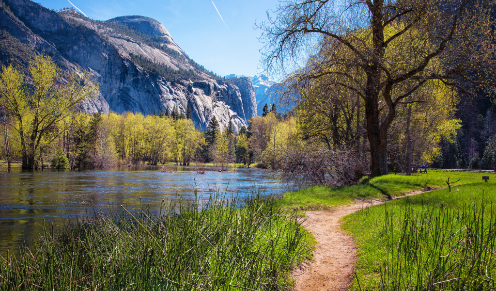 Тропинка у озера у подножия гор в парке
