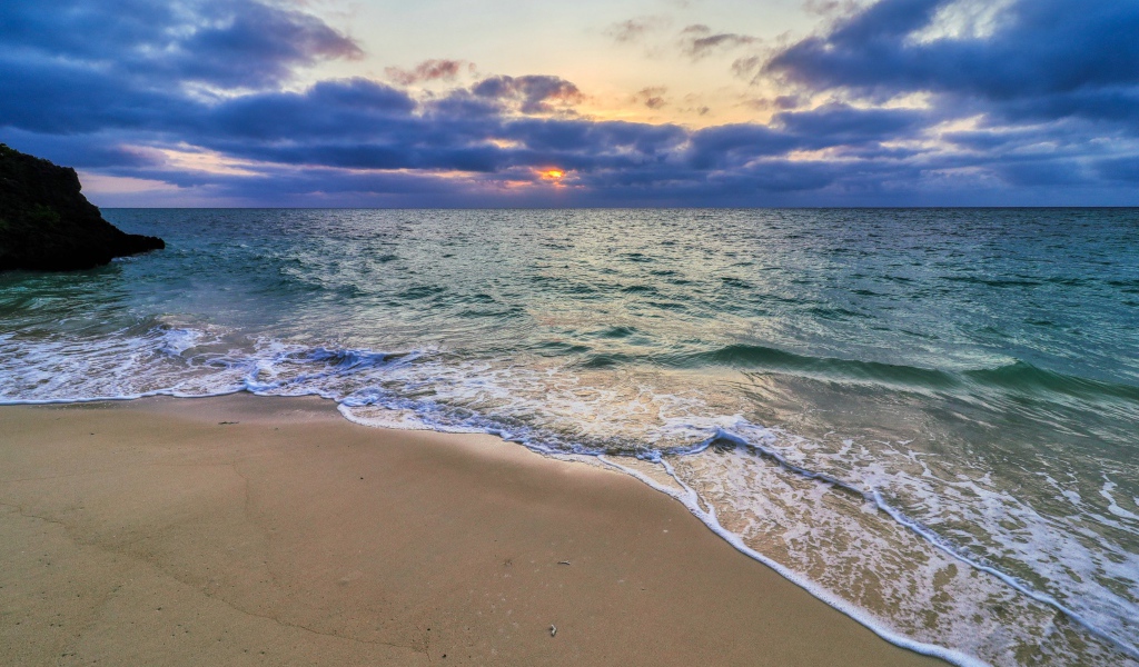 Голубая морская вода на песке на закате солнца