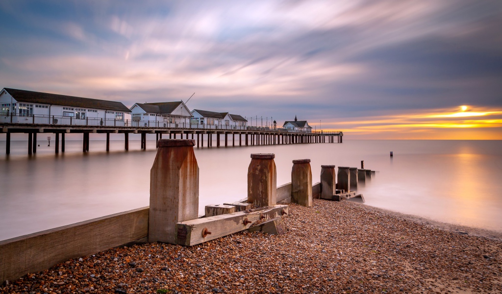 Дома на мосту в спокойной море на закате 