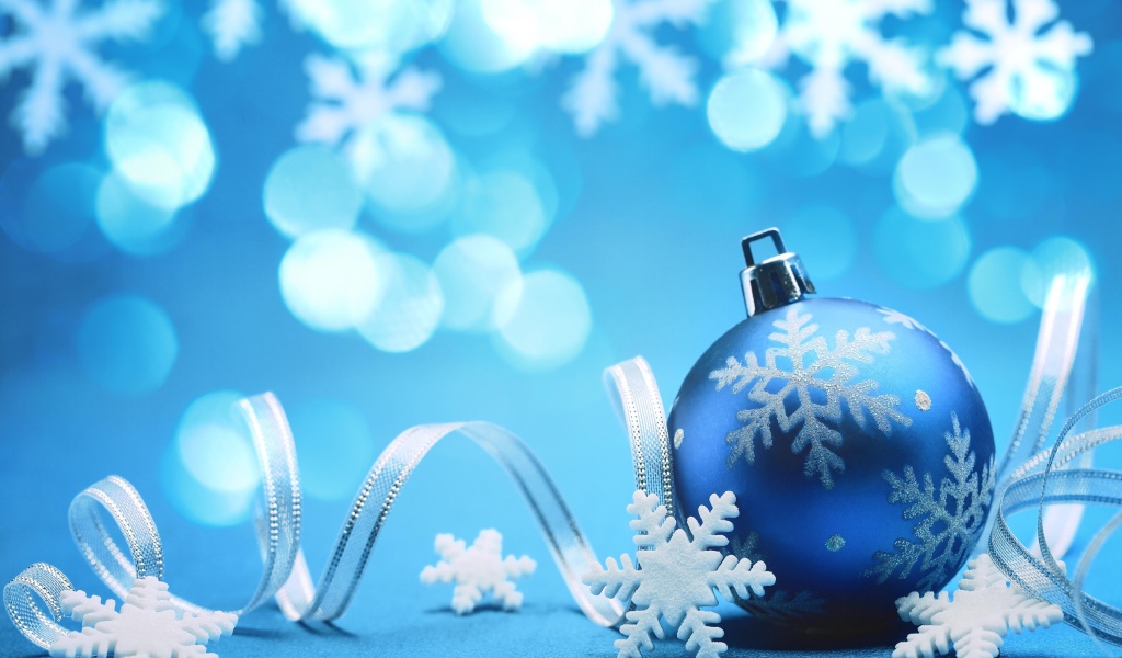 Красивый синий елочный шар с лентой и снежинками на Новый год 