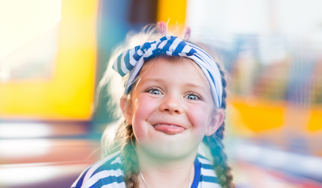 Забавная маленькая девочка с повязкой на голове