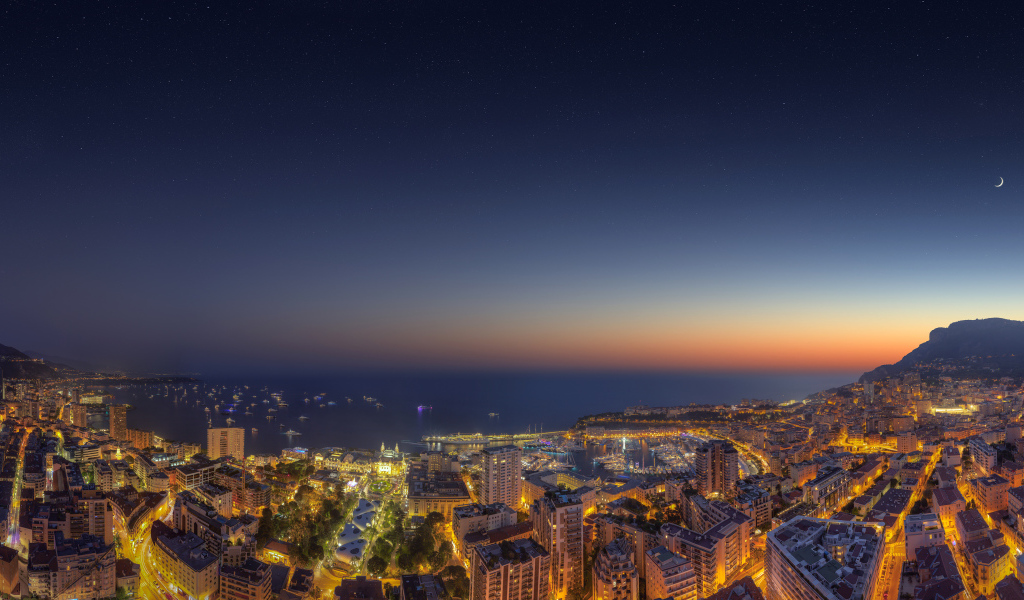View of the night city of Monaco under a blue sky