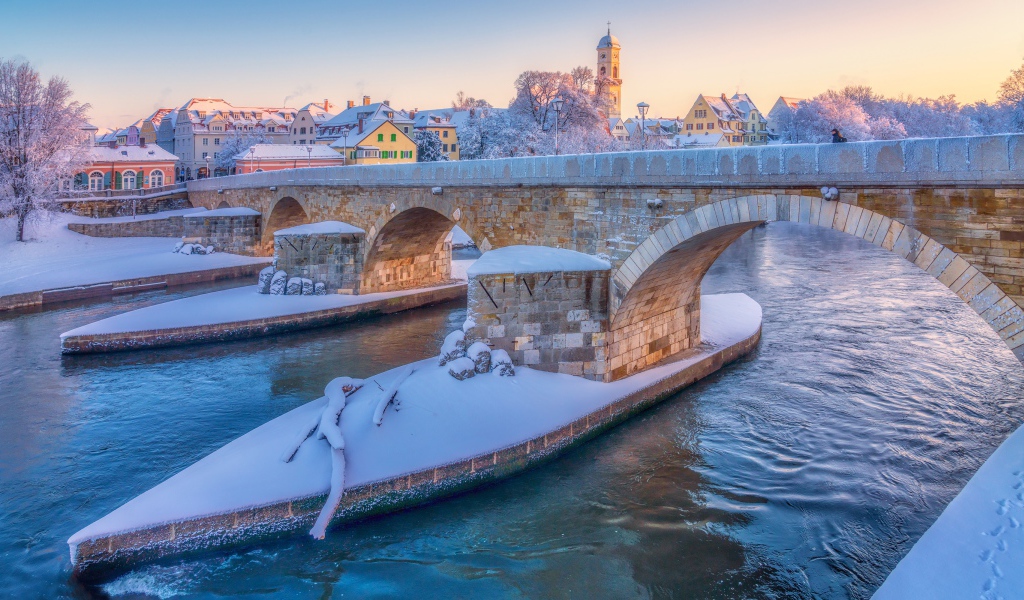 Stone bridge over Danube river in winter, Germany