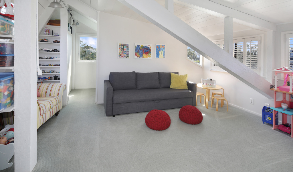 Большой серый диван в белой гостиной комнате