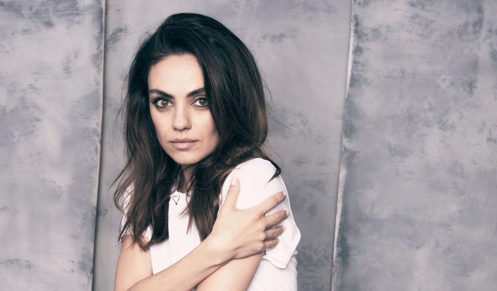 Нежная девушка, актриса Мила Кунис на сером фоне