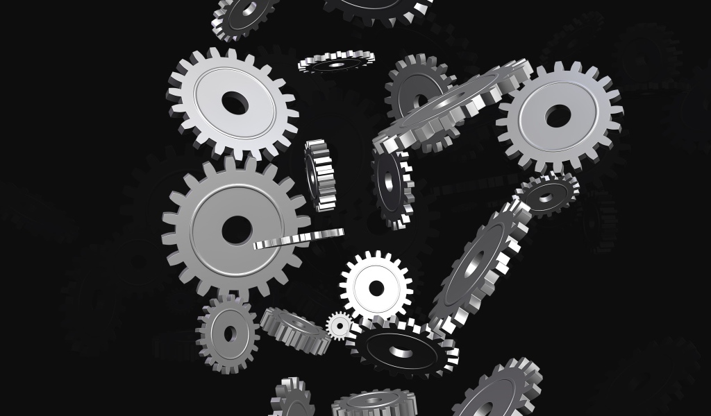Металлические шестеренки в воздухе на черном фоне
