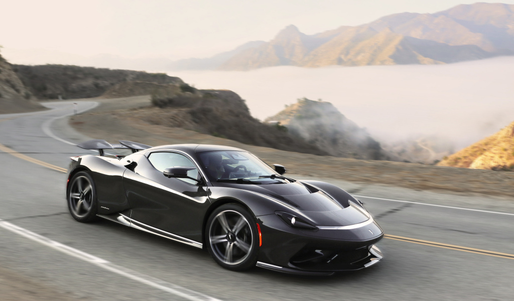 Черный спортивный автомобиль Pininfarina Battista,  2022 года на трассе