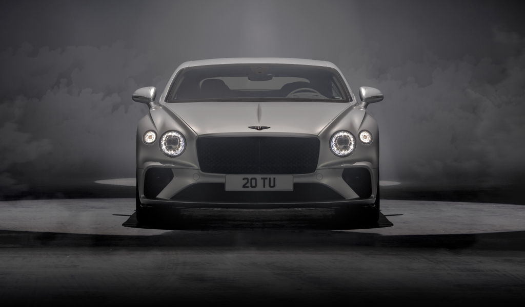 Серебристый автомобиль Bentley Continental GT Speed 2021 года на сером фоне
