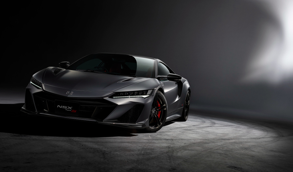 Серый быстрый автомобиль Honda NSX на сером фоне 