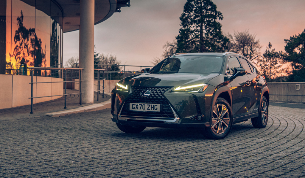 Автомобиль Lexus UX 300e 2021 года с включенными фарами