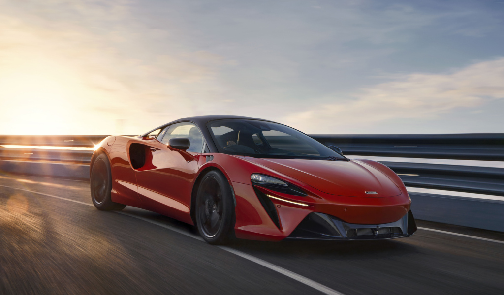 Красный быстрый автомобиль McLaren Artura, 2021 года на трассе