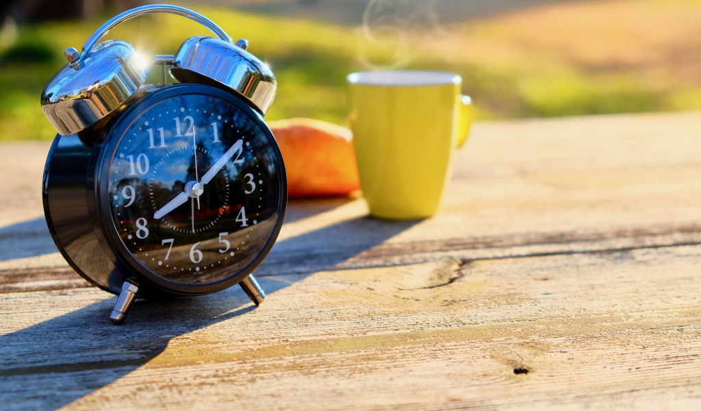 Большой черный будильник на столе