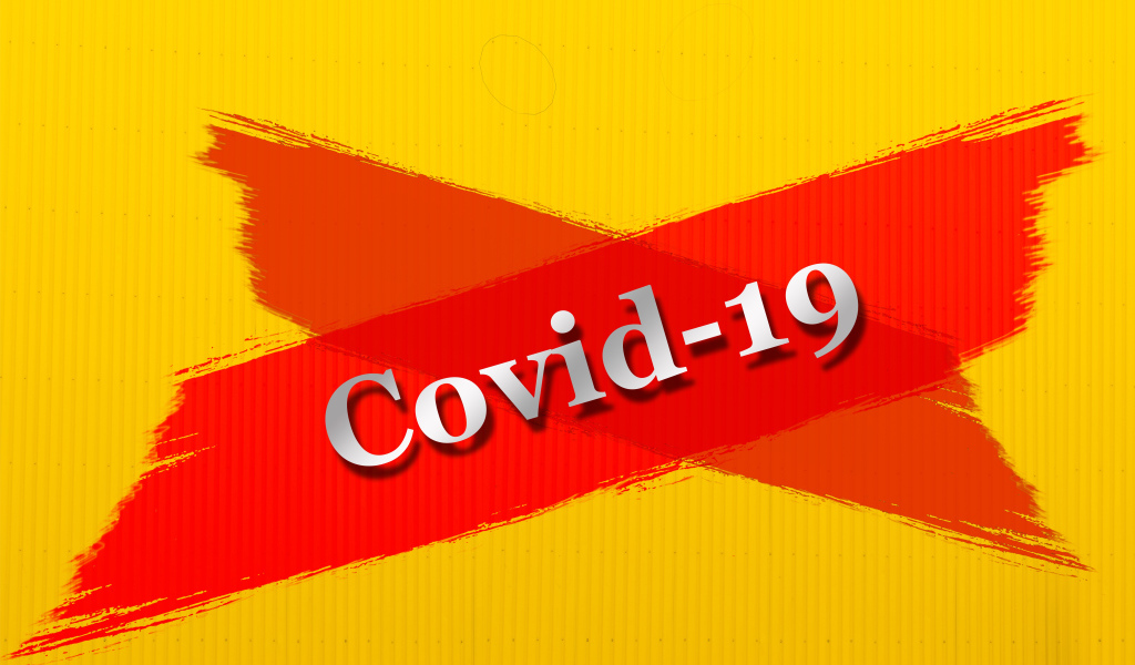 Красная надпись Ковид - 19 на желтом фоне 