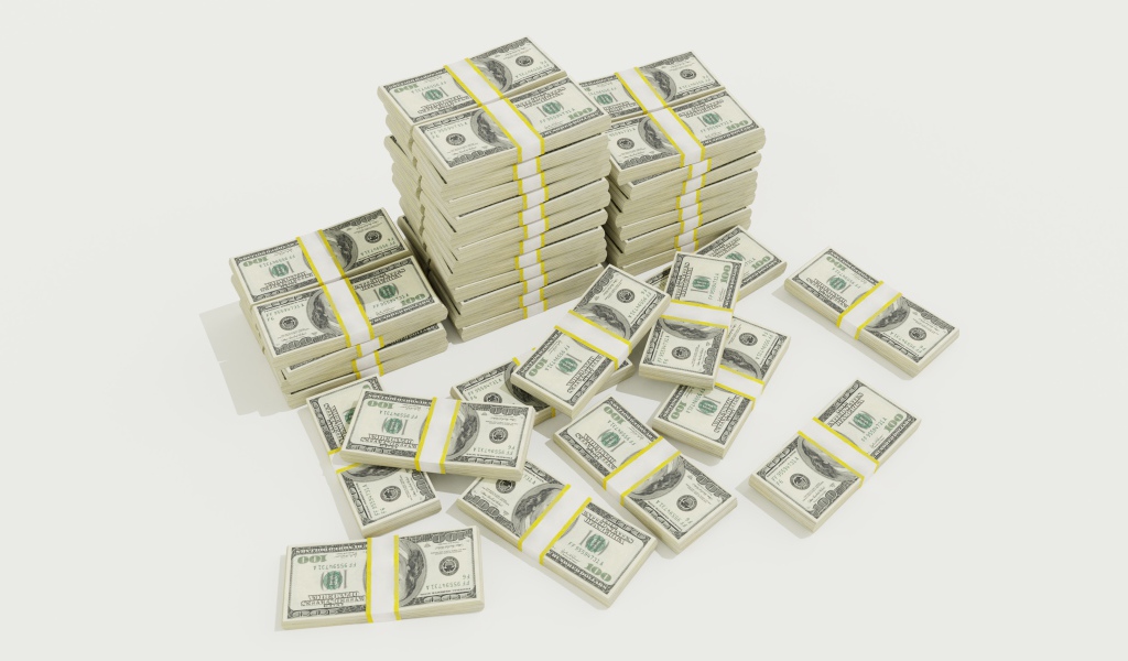 Пачки долларов на белом фоне