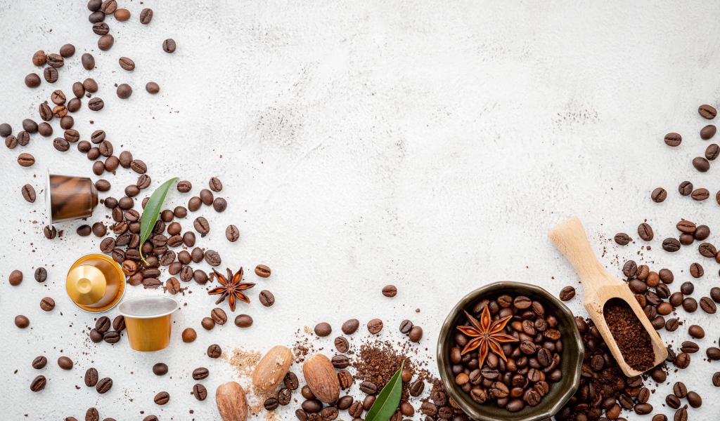 Coffee beans scattered over gray background