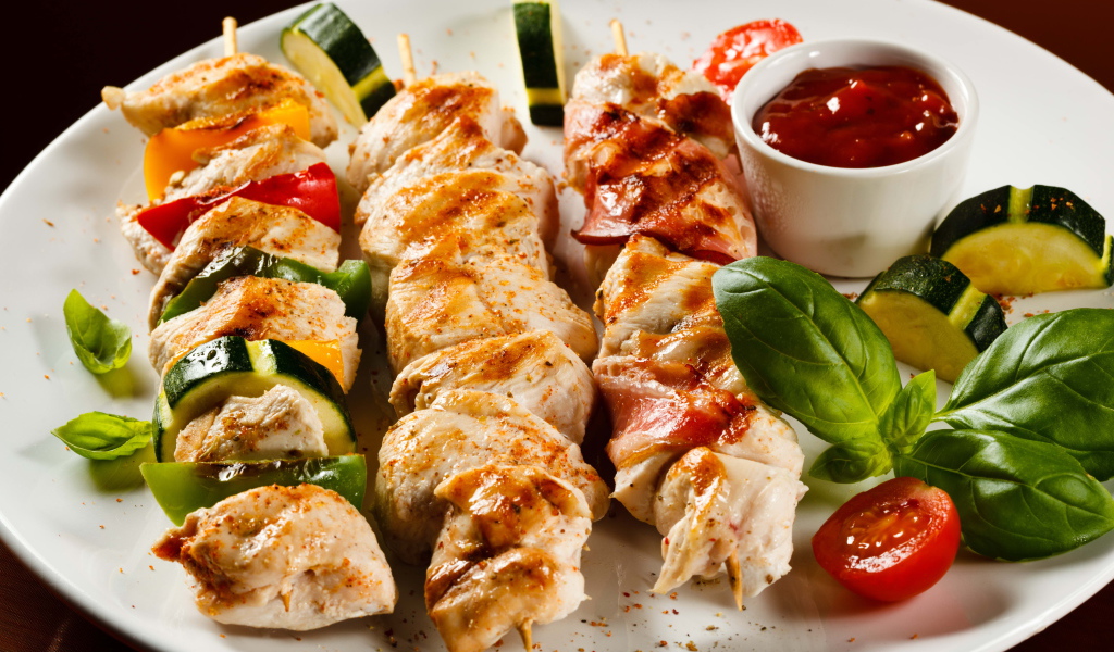 Аппетитный шашлык из курицы с кабачками на тарелке 