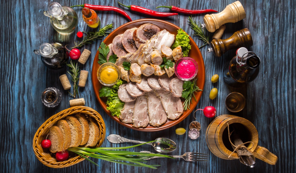 Appetizing cold cuts on the table with spices and bread