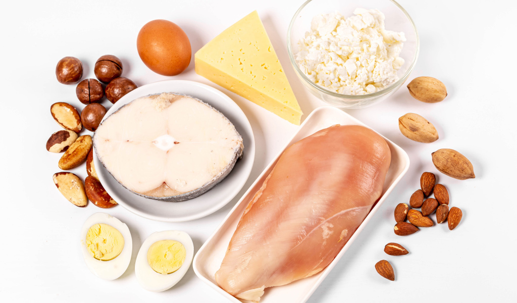 Fresh chicken, fish, nuts, cottage cheese and eggs on the table