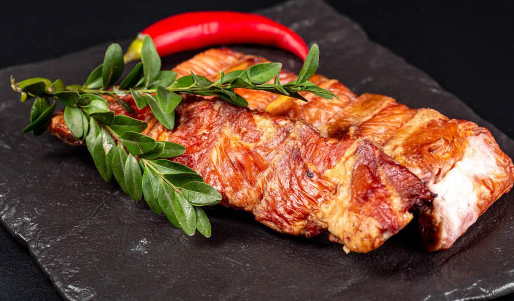 Копченые свиные ребрышки с зелеными листьями