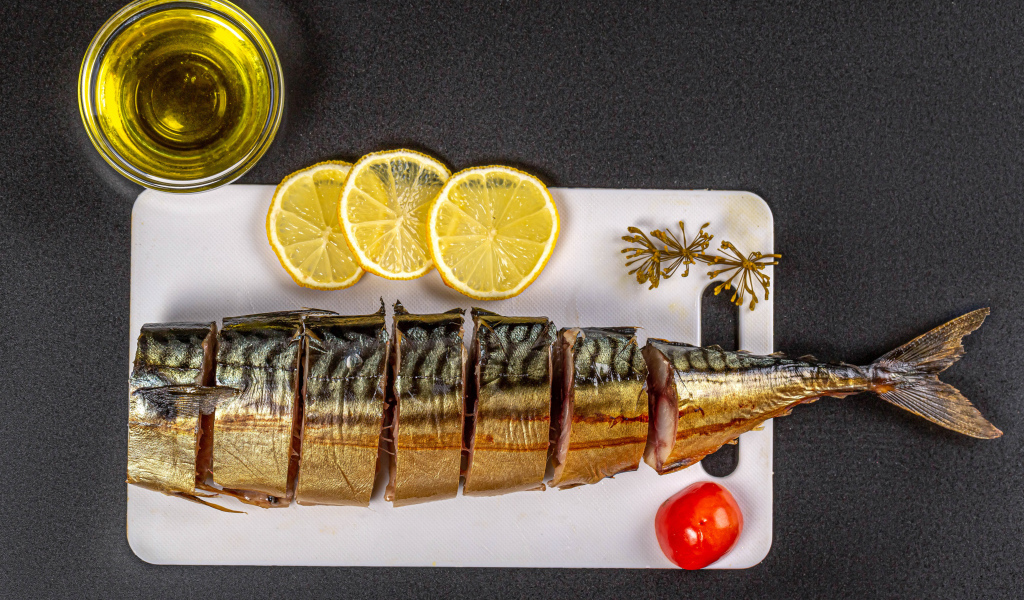 Appetizing mackerel on a board with lemon and butter