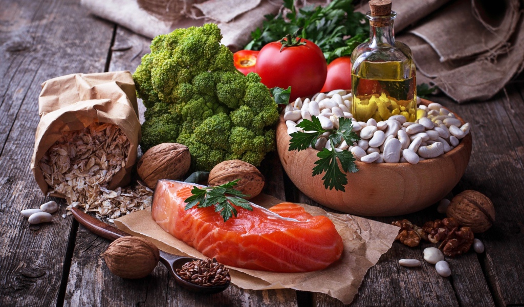 Красная рыба на столе с овощами и фасолью 