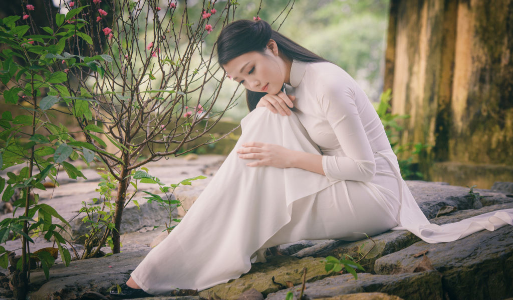 Красивая грустная девушка азиатка в белом платье 