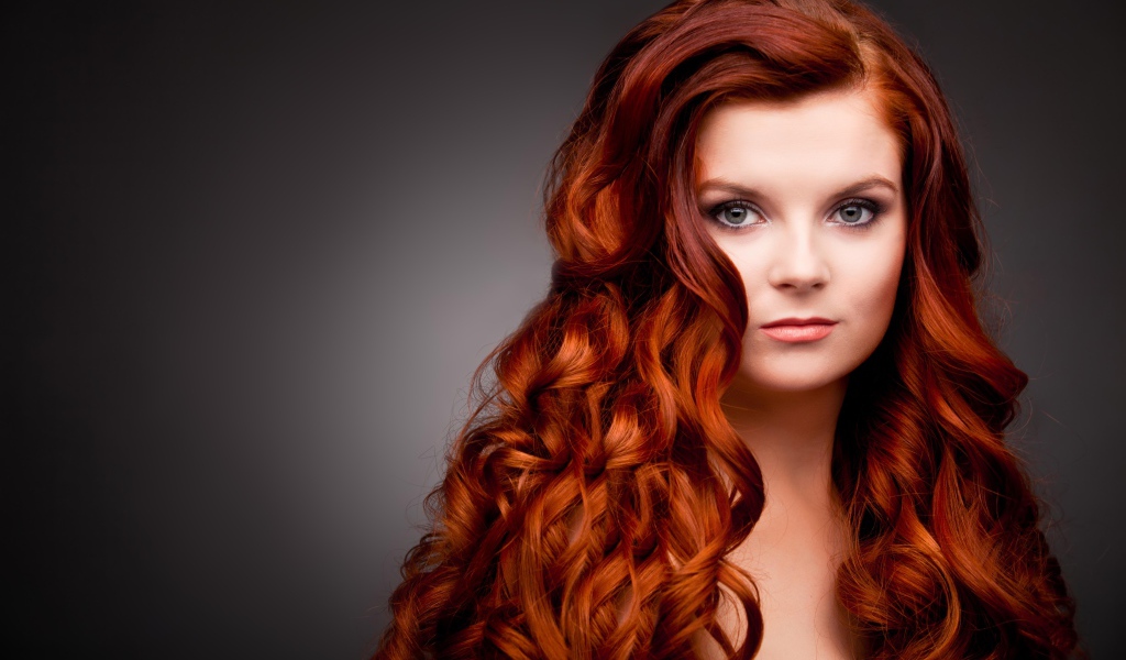 Длинные ярко рыжие волосы у красивой девушки 