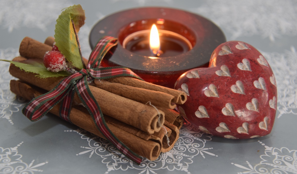 Корица, свеча и сердце на столе 