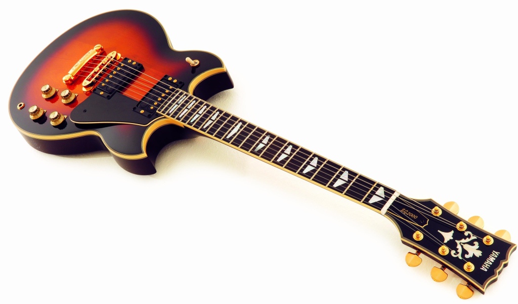 Дорогая гитара на белом фоне 