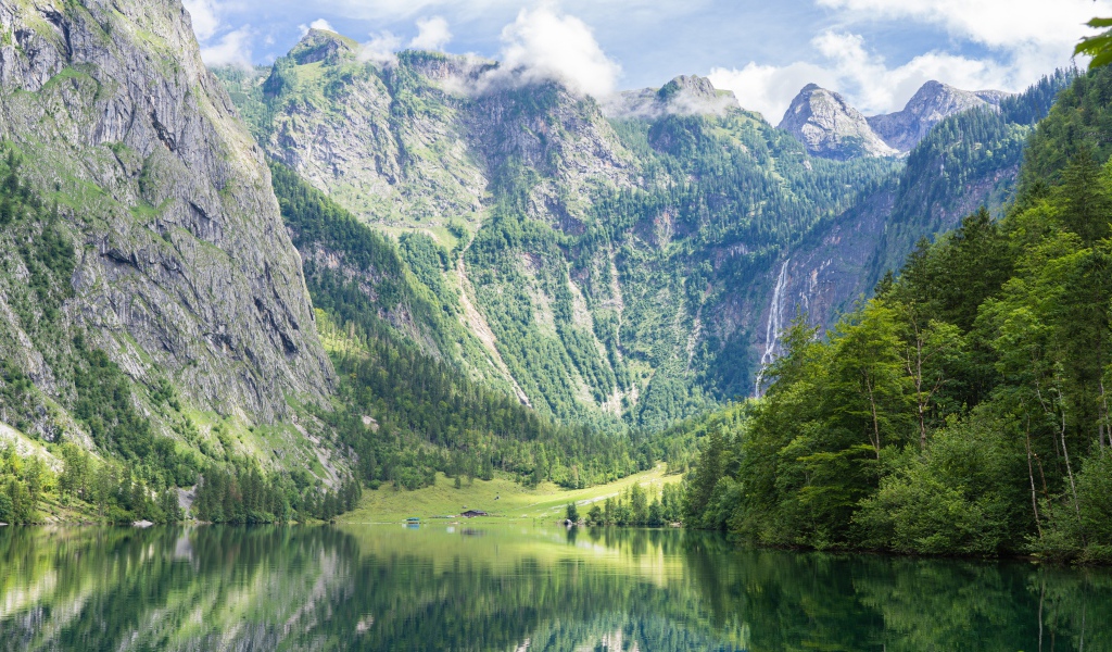 High mountains by the lake with green trees