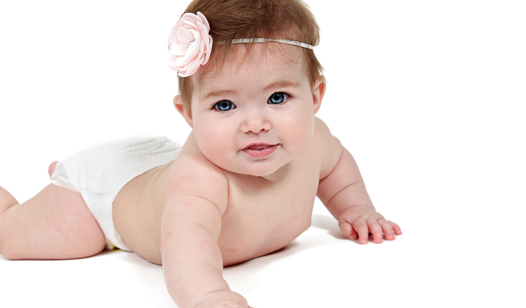 Улыбающаяся маленькая голубоглазая малышка на белом фоне 