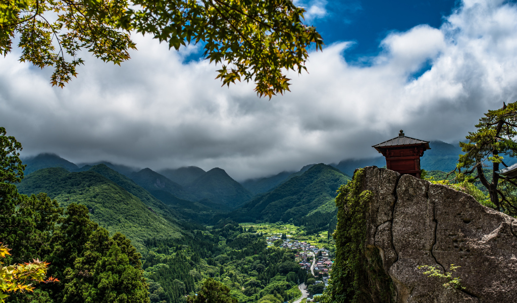 Красивый вид на покрытые зеленью гор под густыми облаками, Япония