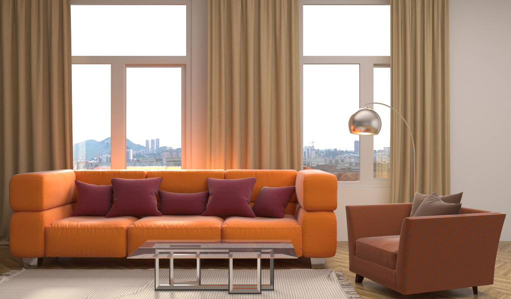 Большой оранжевый диван с подушками у окна 