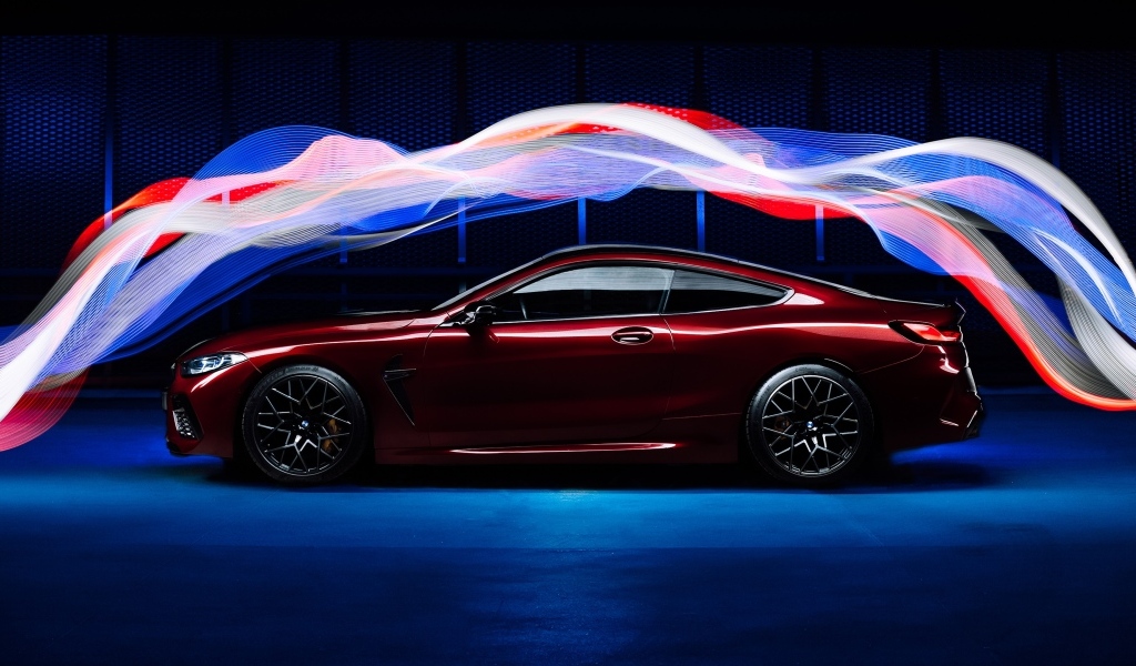 Бордовый автомобиль BMW M8 Competition оптекает волнами