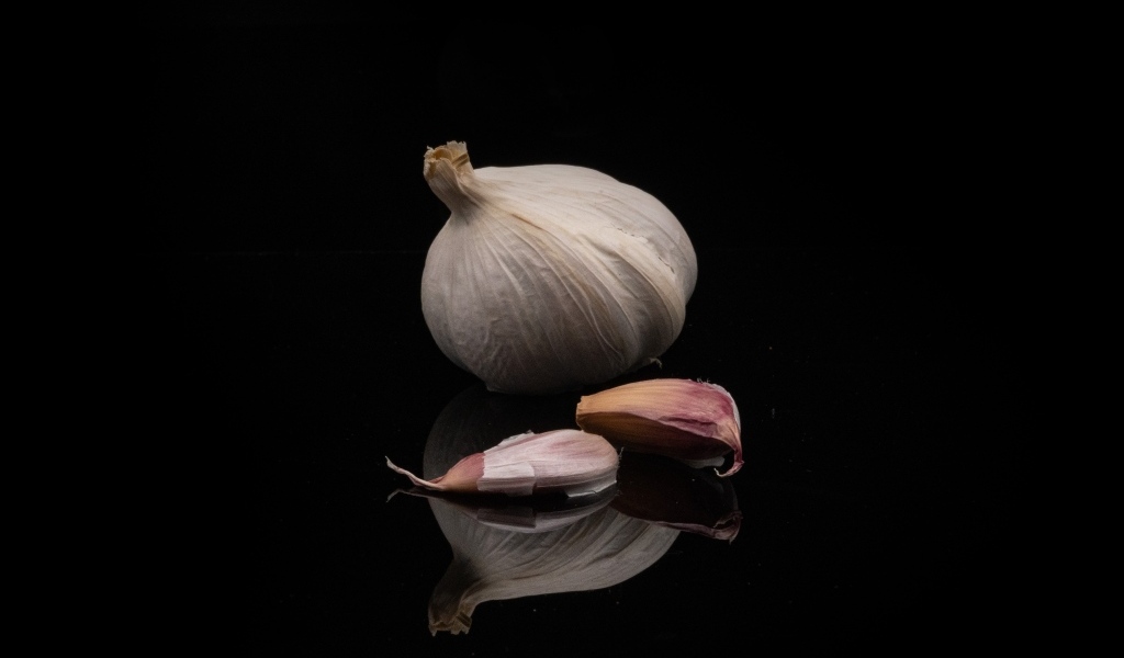 Головка чеснока на черном фоне