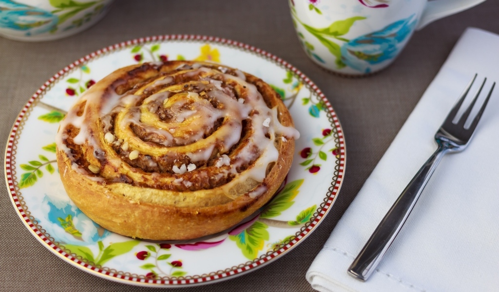 Аппетитная булочка на красивой тарелке 