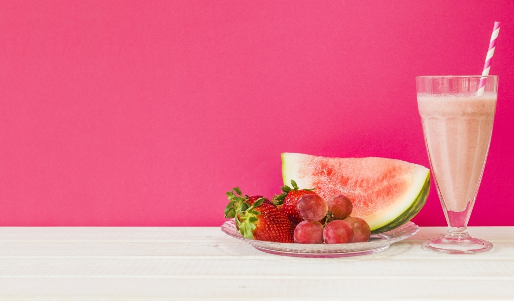 Ягоды на розовом фоне с коктейлем