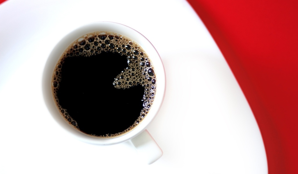 Чашка горячего черного кофе на столе 