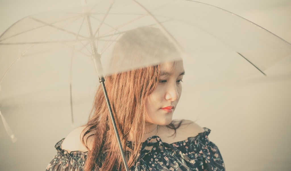 Девушка азиатка под прозрачным зонтом