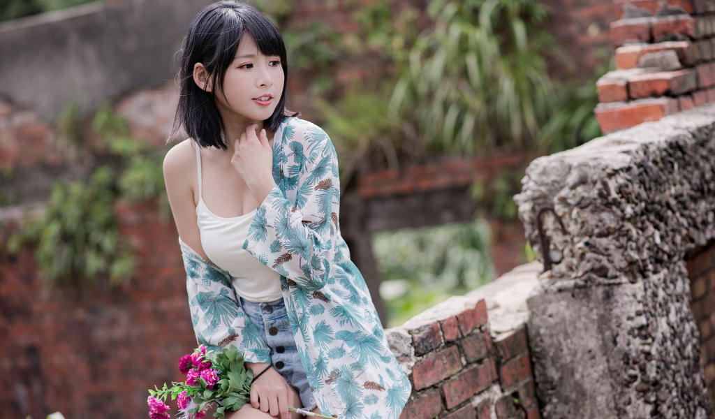 Красивая азиатка с цветком в руке