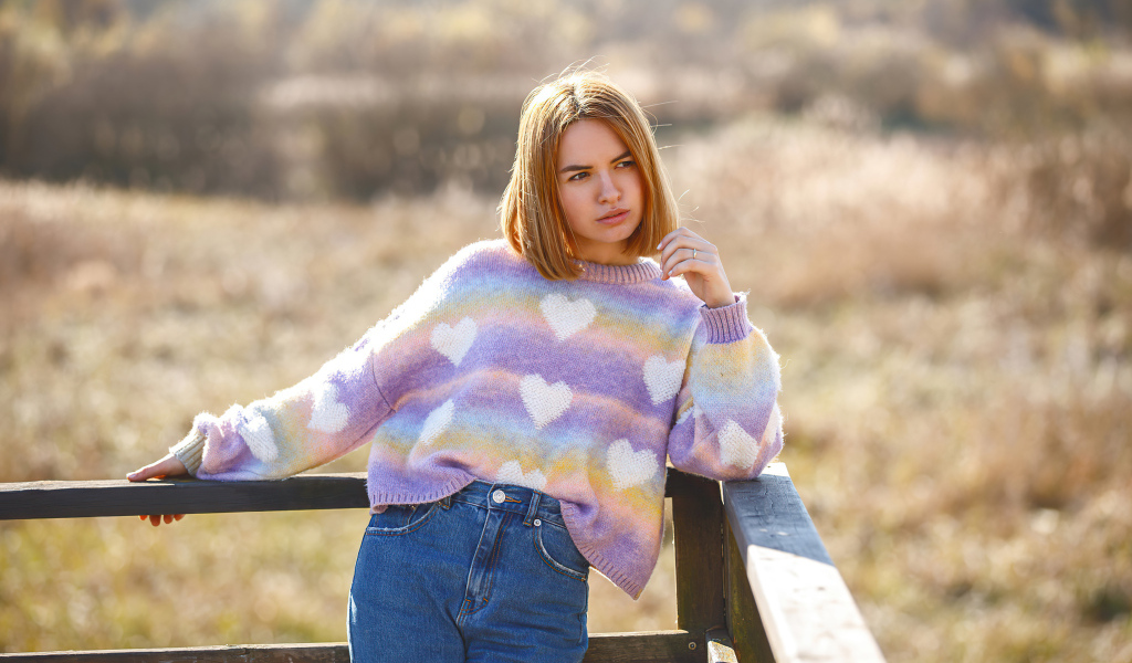 Девушка в свитере и синих джинсах