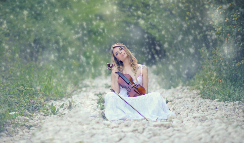 Девушка со скрипкой в руках в лесу