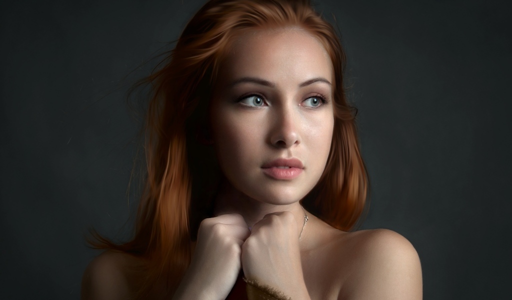 Рыжеволосая девушка с красивыми серыми глазами на сером фоне