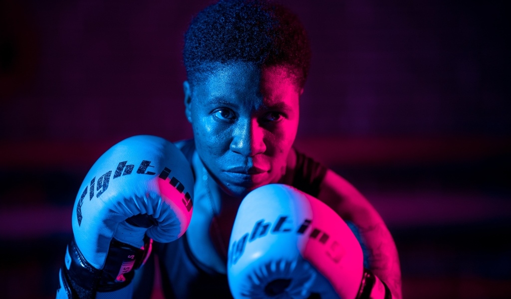 Мужчина в боксерских перчатках на черном фоне
