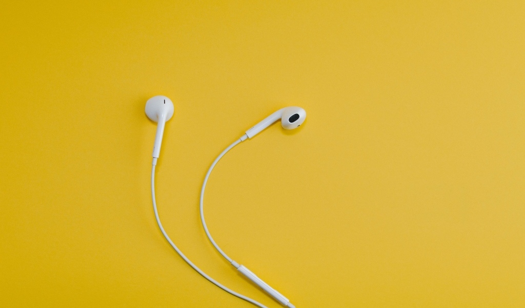 Белые наушники на желтом фоне
