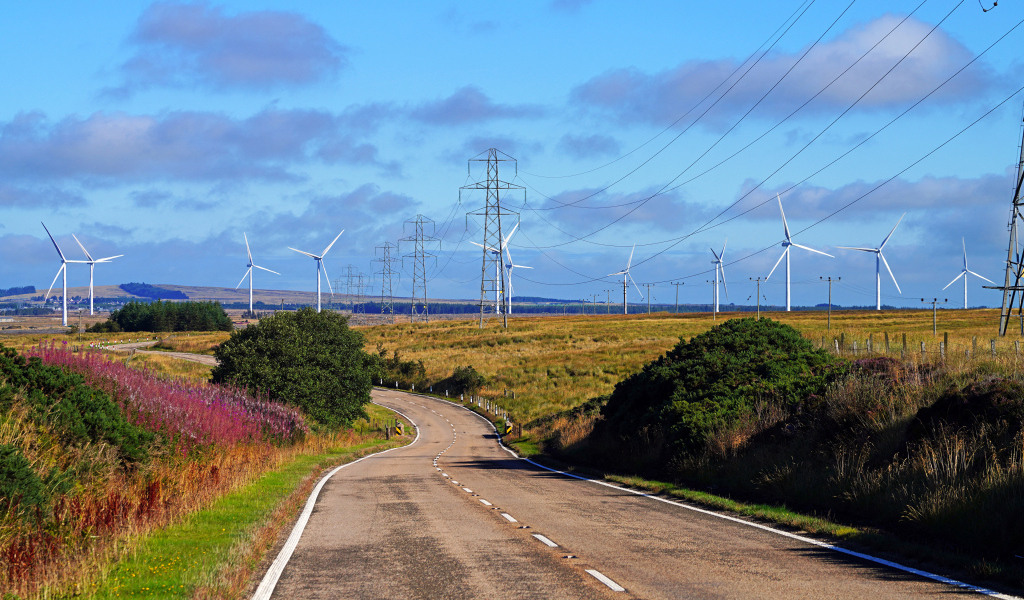 Ветрогенераторы в поле у дороги под голубым небом
